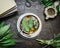 Cup of sage tea with fresh herbs leaves, books and old vintage strainer on rustic wooden background, top view