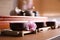 Cup with sakura flower for traditional tea ceremony on wooden table