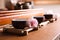 Cup with sakura flower for traditional tea ceremony on wooden table, closeup