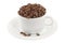 Cup and saucer full of coffee beans, side view