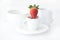 Cup with saucer, milk jug and strawberry