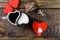 Cup in the shape of hearts, one poured coffee in the other milk, next the chopped chocolate twine tied around the decorative heart