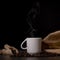 A cup of steaming espresso with coffee beans next to it