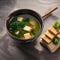 A cup of steaming miso soup with tofu and seaweed1