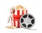 Cup with tasty popcorn, glasses and film reel on white background