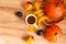 Cup of tea with an autumn decor of pumpkins, plums, textiles and peaches on a wooden background