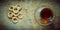 Cup of tea, bagels dry on the old rustic table wood background.