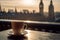 Cup of tea with Big Ben London view on background with sunset, selective focus.