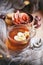 Cup of tea, book, warm pillow, garland light on wooden window sill, Moody seasonal still life. Warm tones, vertical, copy space