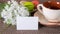 Cup with tea, cakes on the table and white flowers on the background