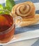 Cup of tea with cinnamon Danish bun