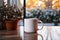 cup of tea or coffee mug on table near window Winter holidays