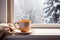 cup of tea or coffee mug on table near window Winter holidays