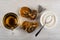 Cup with tea, cookies with poppy, tea bag, spoon in bowl with sugar on wooden table. Top view