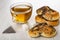 Cup with tea, cookies with poppy, tea bag, sugar cubes on wooden table