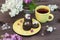 Cup of tea with cookies on a saucer, cute yellow tea service