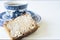 Cup of tea with Dutch spiced bread called Ontbijtkoek or Peperkoek. On white table