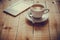 A cup of tea and an ebook reader on a wood table