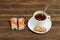 Cup of tea and few bar of muesli. Brown wooden background