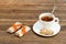 Cup of tea and few bar of muesli. Brown wooden background