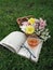 A cup of tea with flower and book in outdoor stilllife