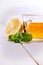 Cup of tea, glass teapot, mint and lemon on a wooden table