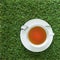 A cup of tea on the grasses background