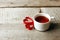 Cup of tea with heart shape on vintage wooden table, minimal concept of valentine mother day morning breakfast