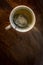 Cup of Tea with infuser in hot smoky water with green tea, mint herbs and honey on a dark wooden background