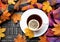 Cup of tea with lemon with scarf and autumn leaves