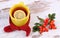 Cup of tea with lemon wrapped woolen scarf, warming beverage for flu, autumn decoration