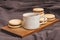 A cup of tea and macaroons cookies lie on a wooden board on a dark tablecloth. Homemade Breakfast Cakes