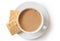 A cup of tea with milk and two square shortbread biscuits isolated on white from above. White ceramic cup and saucer.