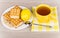 Cup of tea on napkin, biscuits, lemon and lumpy sugar
