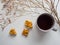 Cup of tea, peanut kozinak and dried flowers on a white background