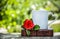 Cup of tea and a red rose. Coffee in the garden. Romantic breakfast. White mug with a heart