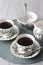 Cup of tea on saucer with teaspoon milk jug and sugar bowl on a green placemat