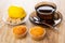 Cup with tea, spoon on saucer, lemon in bowl, muffins