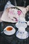 Cup of tea standing near teapot and sugar bowl