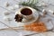 A cup of tea, sticks with sugar cristals, marshmallows and some elements of Christmas decor