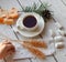 A cup of tea, sticks with sugar cristals, marshmallows and some elements of Christmas decor