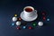 Cup tea and sweets on dark background