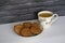 Cup of tea on the table with biscuits cookies black bricks background