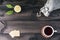 A cup of tea with tea cookies, fresh lime and linen bag on wooden table