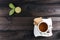 Cup of tea with tea cookies and fresh lime on wooden table