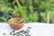 Cup of tea and tea leaf on the stone wall table and the tea plantations background.