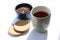 Cup of tea with tea leaves in a bowl and biscuits at the side. Modern minimalistic image