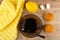 Cup with tea, teaspoon on saucer, lemon, muffins, sugar cubes