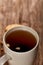Cup of tea on wooden table, top view, close-up, selective focus