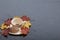 A cup with unapproved coffee. Fallen autumn leaves of yellow and red are scattered on the surface.